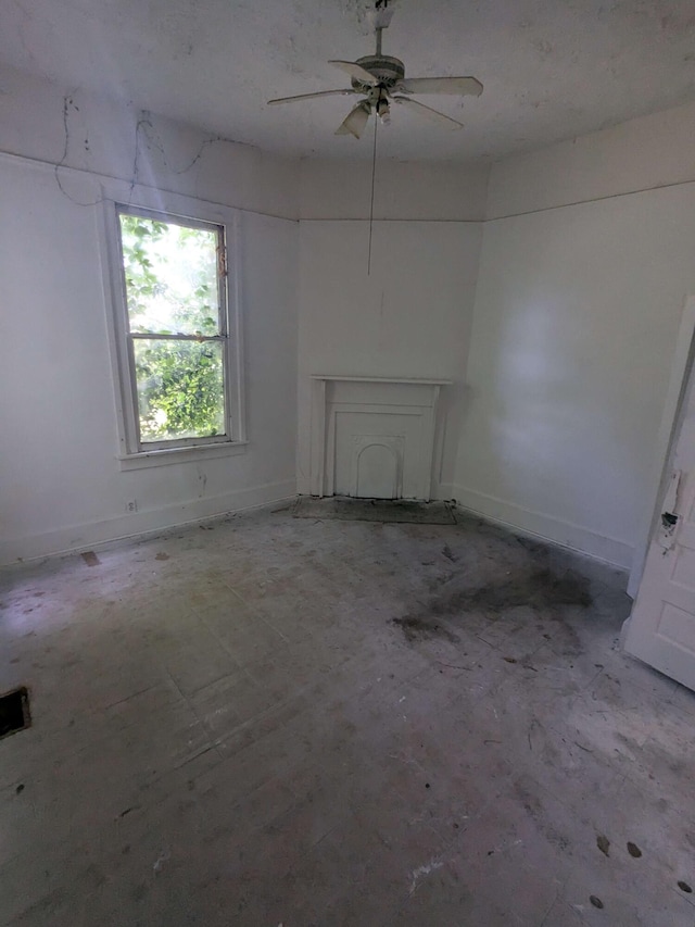 1913 Ellis St, Augusta, GA 30901 - unfurnished living room with a ceiling fan, unfinished concrete floors, and baseboards