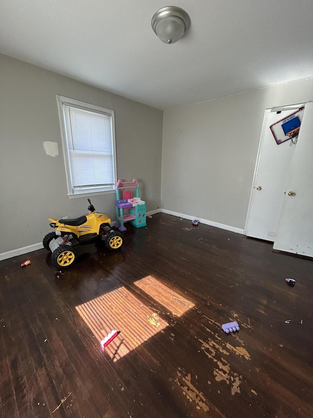 interior space featuring baseboards and wood finished floors