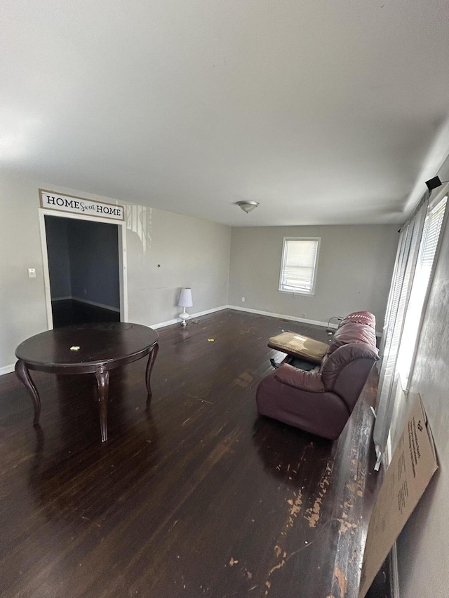 living area featuring baseboards and wood finished floors