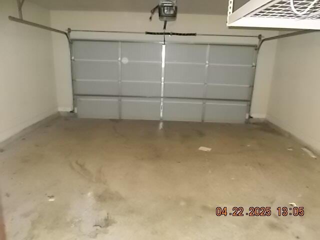 garage with baseboards and a garage door opener