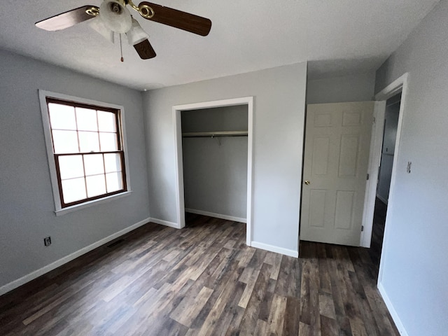 unfurnished bedroom with dark hardwood / wood-style flooring, ceiling fan, and a closet