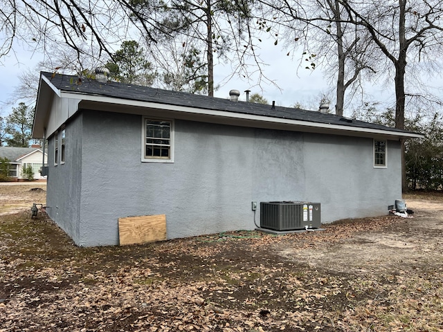 view of side of property with central AC unit