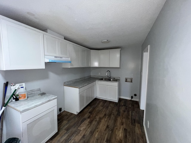 kitchen with a textured ceiling, white cabinetry, dark wood-type flooring, and sink