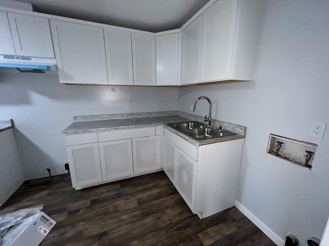 kitchen with white cabinetry, dark wood-type flooring, and sink