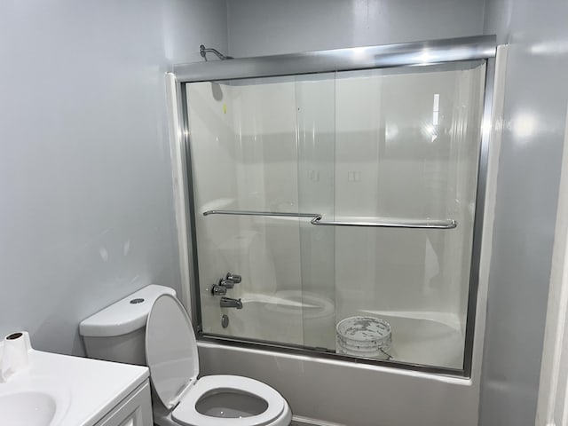 full bathroom with vanity, toilet, and enclosed tub / shower combo