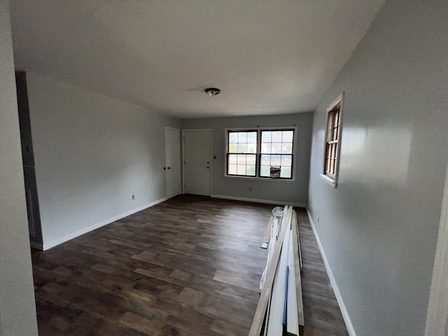 spare room with dark wood-type flooring