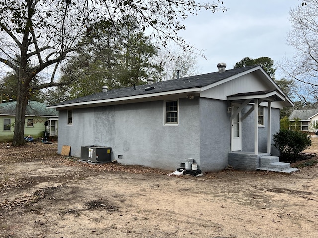 rear view of house with central air condition unit