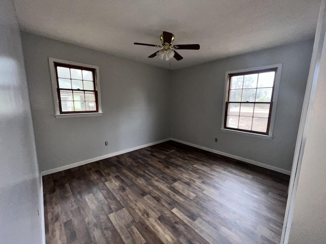 unfurnished room featuring dark hardwood / wood-style flooring and ceiling fan