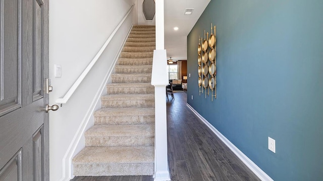 stairs featuring hardwood / wood-style floors