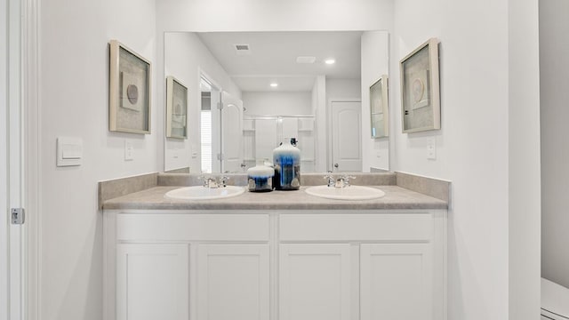 bathroom featuring an enclosed shower and vanity