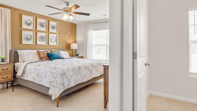 bedroom featuring light carpet and ceiling fan