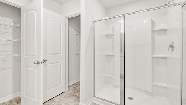 bathroom featuring a shower with door