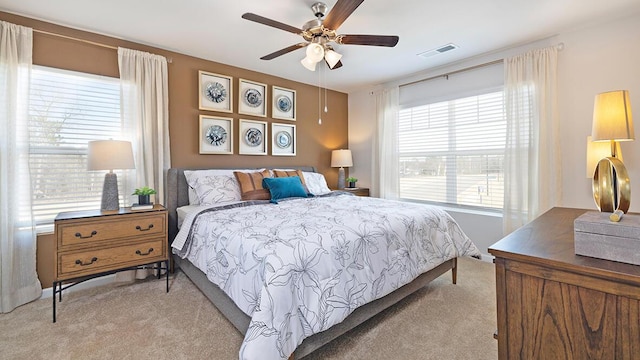 bedroom featuring ceiling fan and light colored carpet