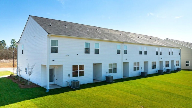 back of property featuring a yard and central AC unit