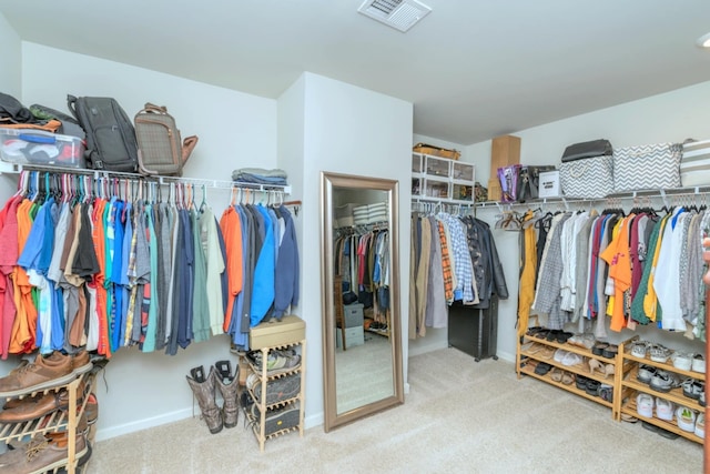 walk in closet with carpet flooring