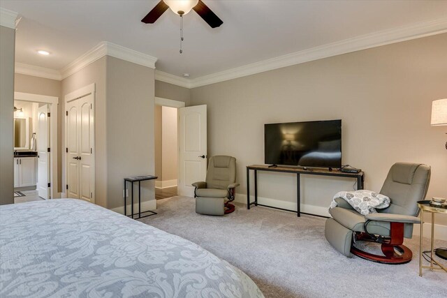 carpeted bedroom with ceiling fan and ornamental molding