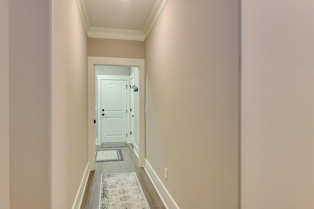 hall with hardwood / wood-style floors and ornamental molding