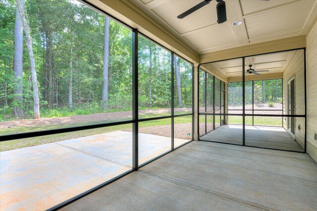 unfurnished sunroom with ceiling fan and a healthy amount of sunlight