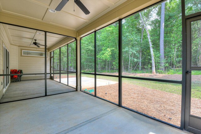 unfurnished sunroom featuring a healthy amount of sunlight and coffered ceiling