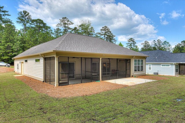 rear view of property featuring a sunroom, a yard, and a patio