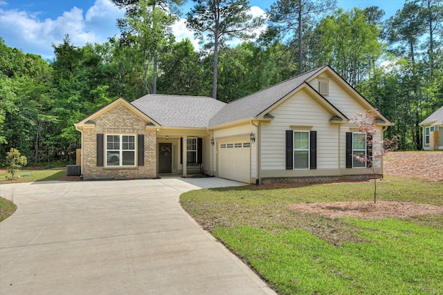 ranch-style home featuring a garage, a front lawn, and central air condition unit