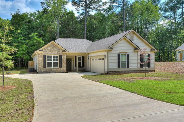 single story home with central AC unit, a garage, and a front yard