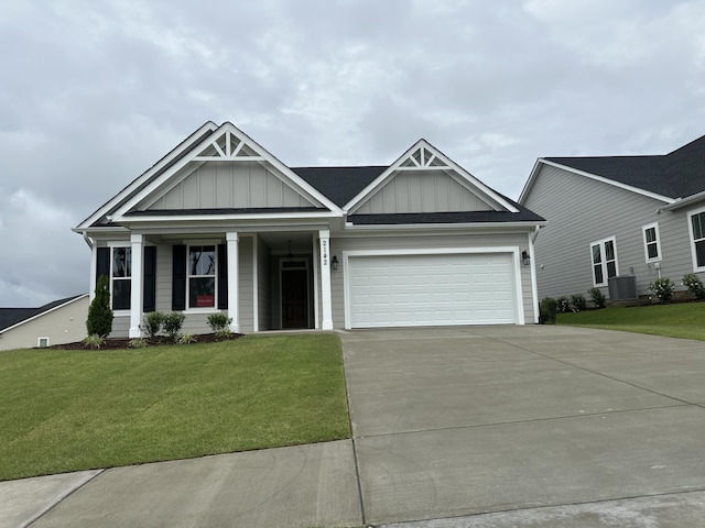 2142 Sinclair Dr Unit Sc86, Grovetown, GA 30813 - view of front facade with board and batten siding, concrete driveway, a front lawn, a garage, and cooling unit