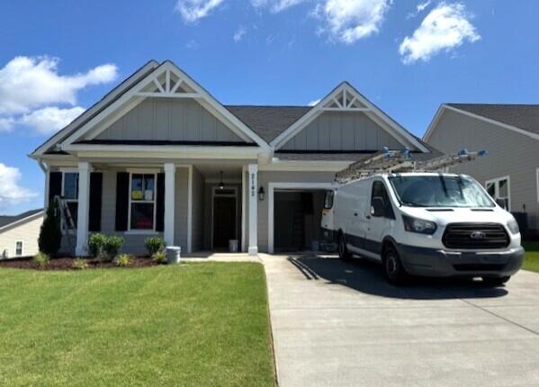 2142 Sinclair Dr Unit Sc86, Grovetown, GA 30813 - view of front of home with driveway, an attached garage, a front yard, and board and batten siding
