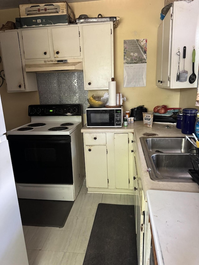 3216 Alpine Rd, Augusta, GA 30909 - kitchen with under cabinet range hood, electric stove, light countertops, and a sink