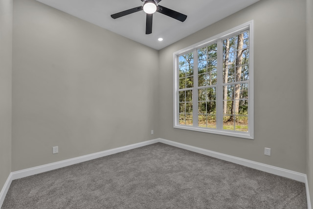 empty room featuring carpet flooring and ceiling fan