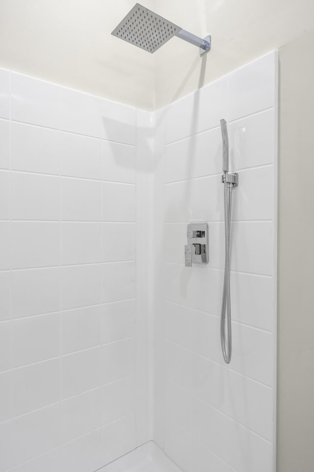 bathroom with tiled shower