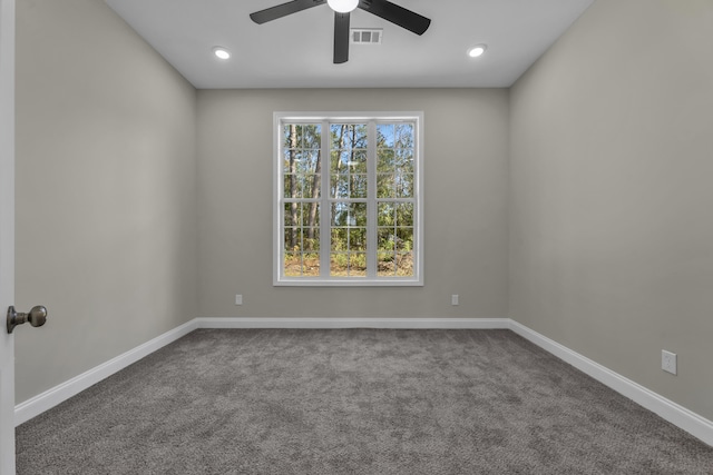 spare room featuring ceiling fan and carpet