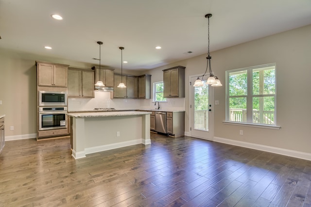 kitchen featuring a center island, dark hardwood / wood-style flooring, stainless steel appliances, and hanging light fixtures