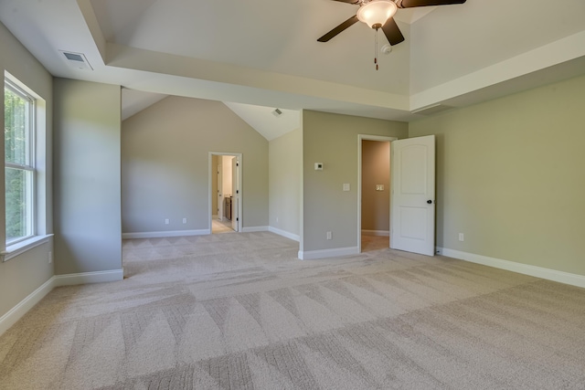 empty room with ceiling fan, light carpet, and lofted ceiling