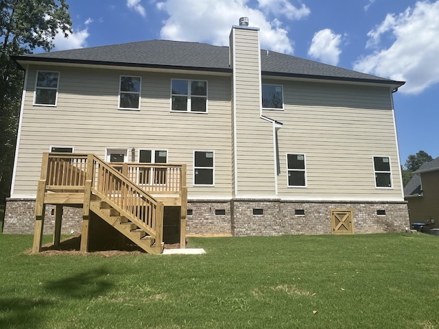 back of house with a lawn and a wooden deck