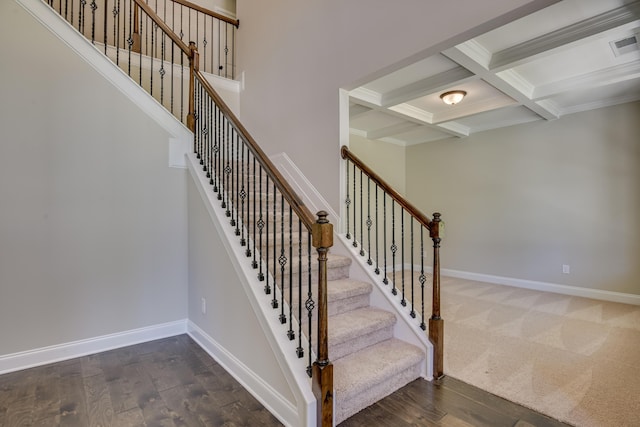 stairway featuring hardwood / wood-style flooring, beam ceiling, and coffered ceiling