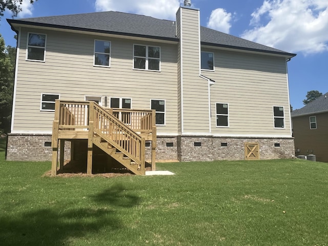 back of house with a yard and a deck