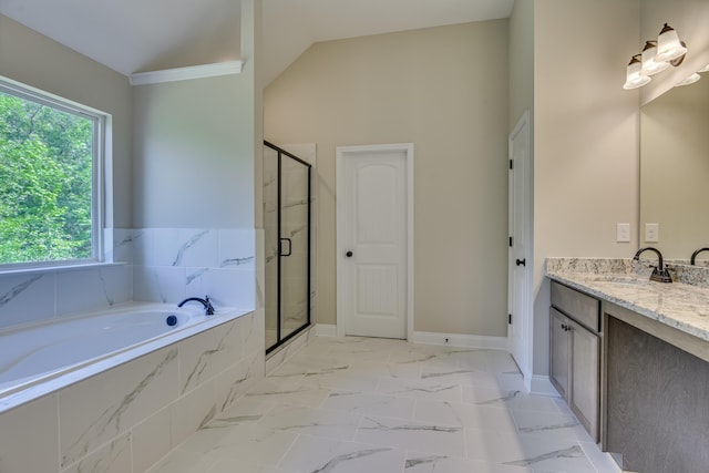 bathroom with separate shower and tub, vanity, and vaulted ceiling