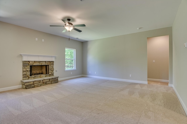 unfurnished living room featuring light carpet, a fireplace, and ceiling fan