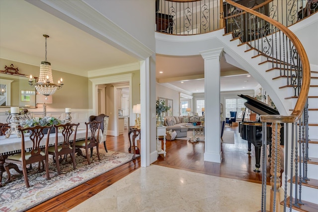 612 Emerald Xing, Evans, GA 30809 - entrance foyer featuring stairway, crown molding, a chandelier, a high ceiling, and wainscoting