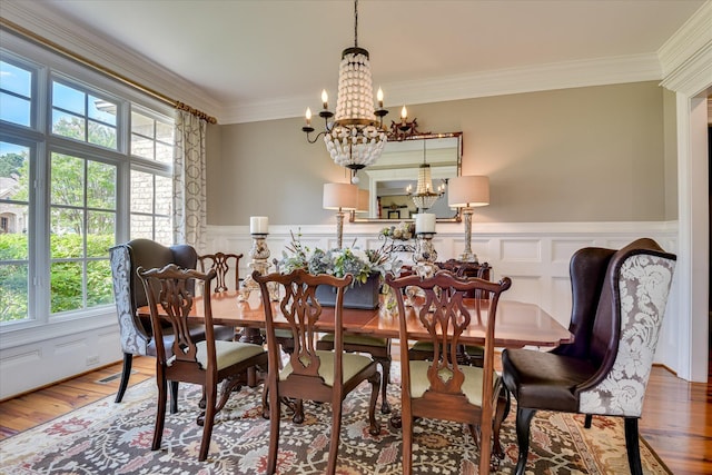 612 Emerald Xing, Evans, GA 30809 - dining space with a chandelier, a wainscoted wall, wood finished floors, and ornamental molding