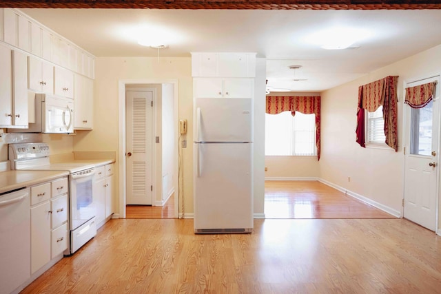 kitchen featuring white cabinetry, white appliances, and light hardwood / wood-style floors