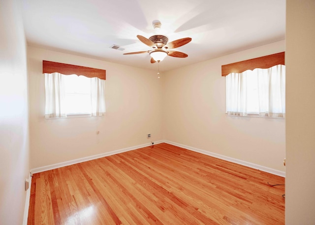 spare room with wood-type flooring and ceiling fan