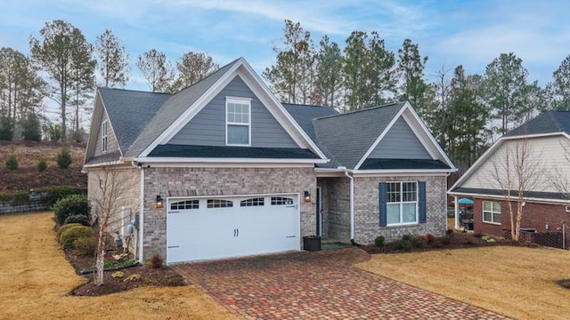 craftsman-style house featuring a garage and a front yard