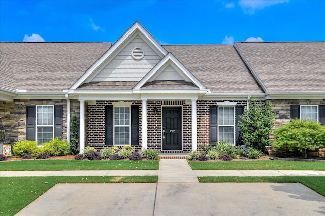 272 Harvester Dr, North Augusta, SC 29860 - view of front of house with a shingled roof, brick siding, and covered porch