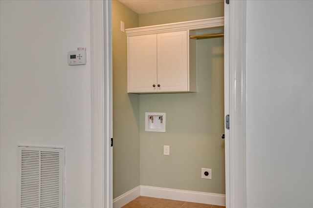 272 Harvester Dr, North Augusta, SC 29860 - laundry area featuring cabinet space, washer hookup, electric dryer hookup, and light tile patterned floors