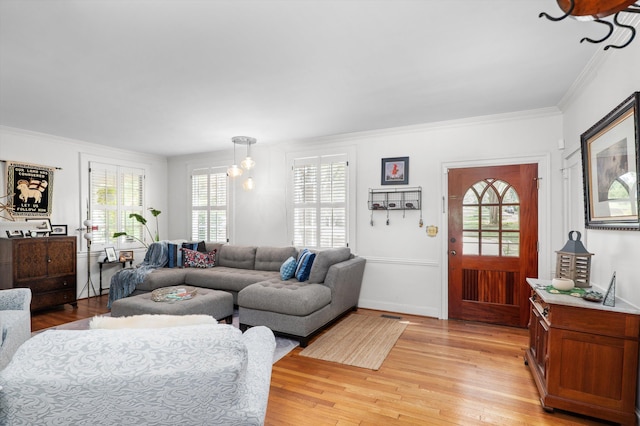 living area with light wood finished floors and crown molding