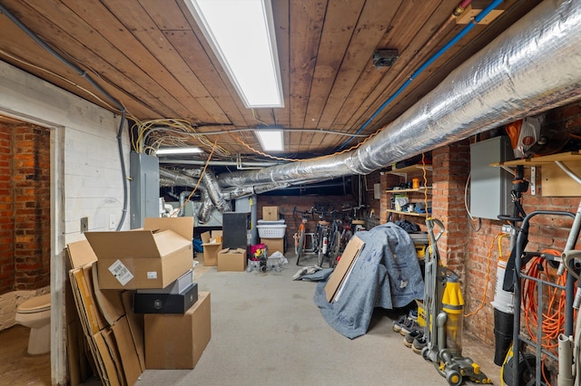 unfinished below grade area featuring brick wall and electric panel