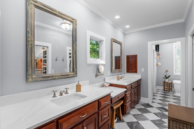 bathroom with plenty of natural light, tile patterned floors, ornamental molding, vanity, and a freestanding tub