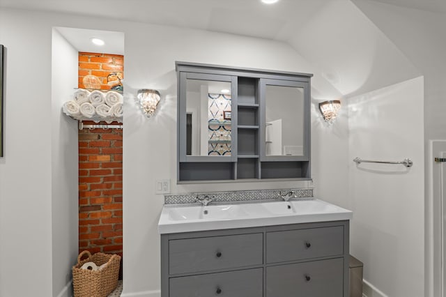 full bathroom with baseboards and double vanity
